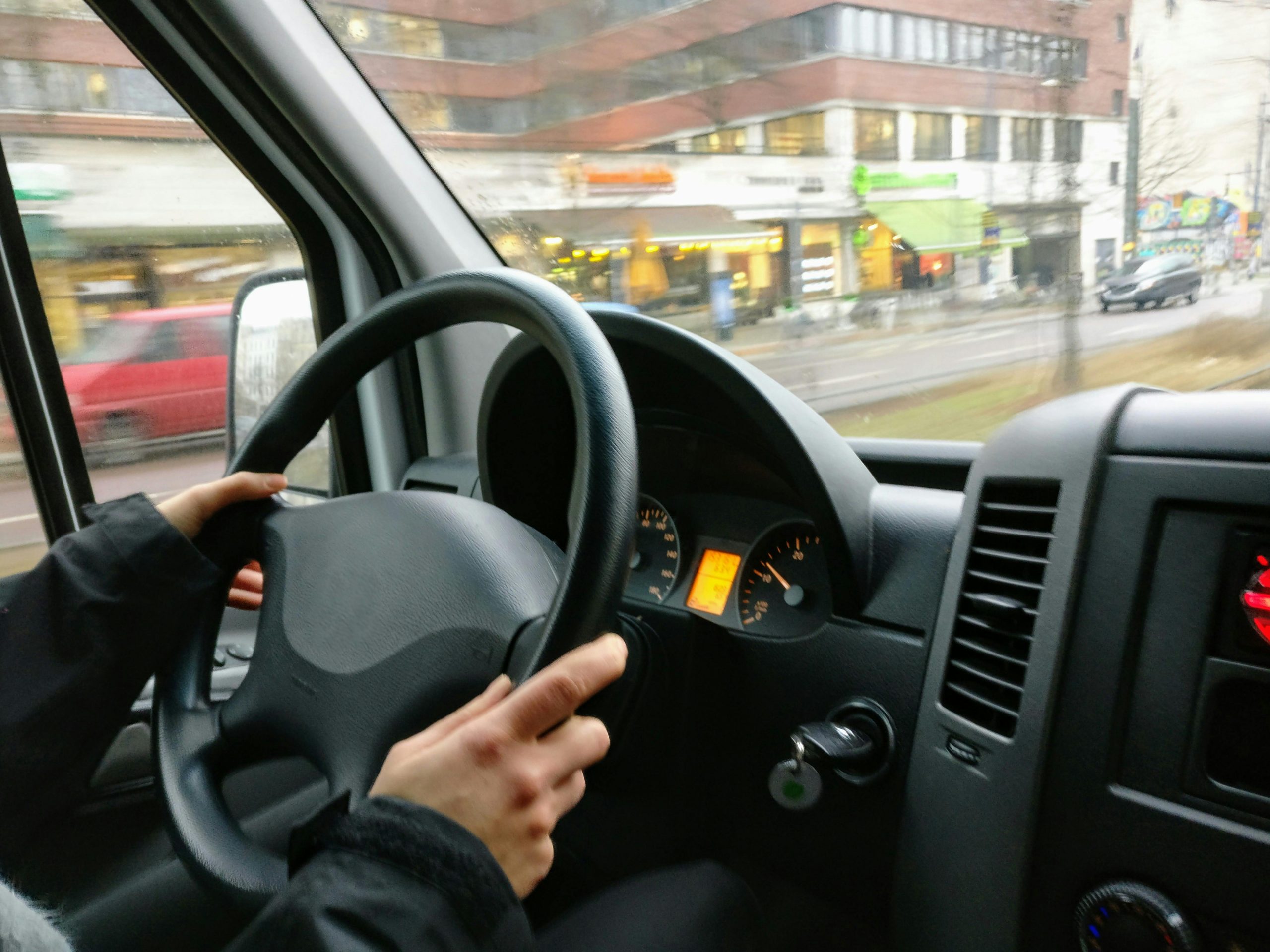 driver with hands on the steering wheel