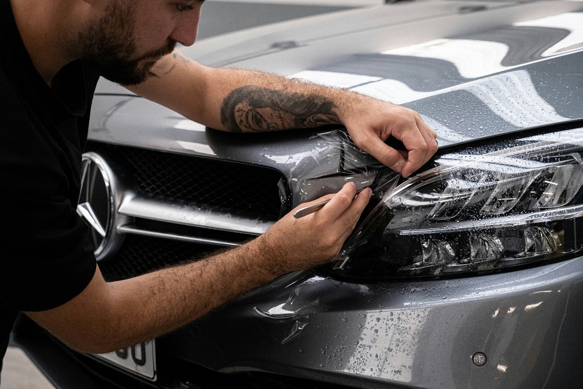 mechanic fixing a headlight